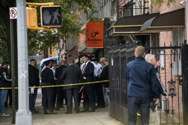 NYPD investigates the scene of a shooting in the Brooklyn borough of New York on Saturday, Oct. 12, 2019. [Photo: AP/Jeenah Moon]