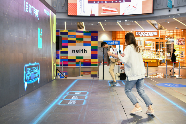 Young people step on a ‘kindness keyboard’ installation created by UNICEF, where they can send kind messages to wipe out meanness in the cyberspace, in a shopping mall in Shanghai in early October 2019. UNICEF unveiled a life-size keyboard filled with positive words as part of a campaign to help end cyberbullying in China. [Photo: UNICEF/Zhang Yuwei]