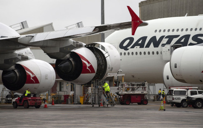 This picture taken on June 1, 2018 shows ground staff preparing a Qantas Airbus A380 aircraft for flight at the Sydney International airport. [Photo: AFP]