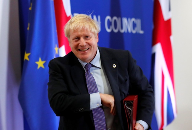 Britain's Prime Minister Boris Johnson leaves the podium after addressing a press conference at a European Union leaders’ summit in Brussels on Thursday, October 17, 2019. Britain and the European Union reached a tentative new Brexit deal on Thursday in the hope of bringing to an end their three-year divorce battle. [Photo: AP/IC]