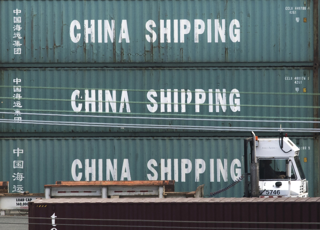 A truck passes by China Shipping containers at the Port of Los Angeles, California on September 1, 2019. [Photo: AFP/ Mark RALSTON] 