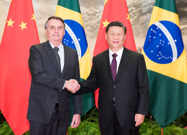 President Xi Jinping shakes hands with visiting Brazilian President Jair Messias Bolsonaro at the Great Hall of the People in Beijing, October 25, 2019. [Photo: Xinhua]