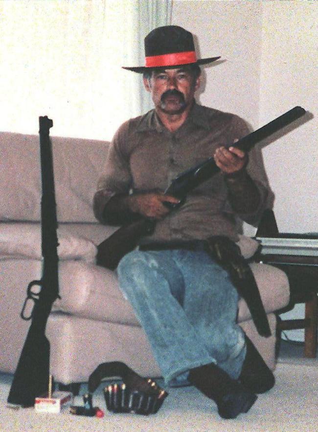 Ivan Milat is shown in an undated photograph with a rifle and pistol and a favorite cowboy hat. [File photo: Fairfax Ltd/AFP]