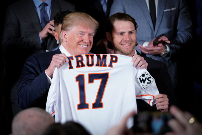 US President Donald Trump poses with a jersey presented to him by Josh Reddick during an event in honor of 2017 World Series Champion Houston Astros in the East Room of the White House on March 12, 2018 in Washington, DC. [File photo: AFP/Mandel Ngan]