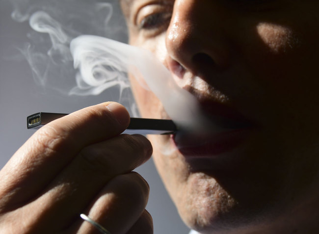 In this file illustration taken on October 02, 2018, a man exhales smoke from an electronic cigarette in Washington, DC. [Photo: AFP]