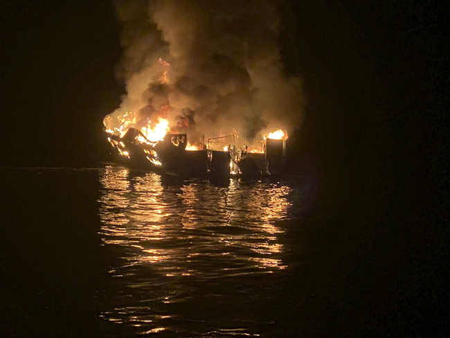 In this Sept. 2, 2019, file photo provided by the Santa Barbara County Fire Department, the dive boat Conception is engulfed in flames after a deadly fire broke out aboard the commercial scuba diving vessel off the Southern California Coast. The widow of Justin Dignam, one of the 34 people who died in the fire, has filed a lawsuit against the boat's owners, making it the first claim from one of the 34 victims' families. [Photo: Santa Barbara County Fire Department via AP]