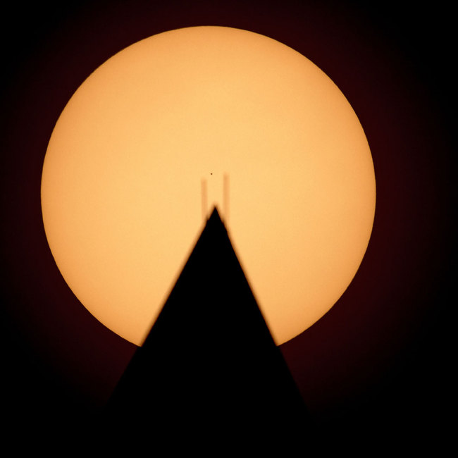 This image provided by NASA shows the planet Mercury in silhouette, low center, as it transits across the face of the sun behind the Washington Monument in Washington, Monday, Nov. 11, 2019. [Photo: AP]