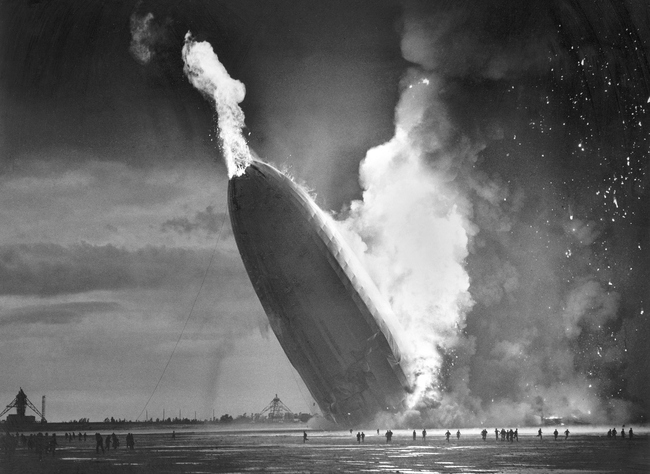 In this May 6, 1937 file photo, the German dirigible Hindenburg crashes to earth in flames after exploding at the U.S. Naval Station in Lakehurst, N.J. [Photo: AP/Murray Becker]