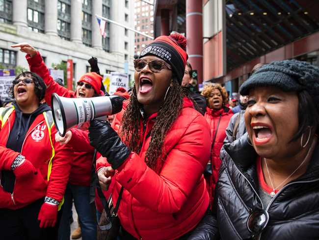 In this Oct. 23, 2019 file photo, thousands of striking Chicago Teachers Union and their supporters rally at the Thompson Center in downtown Chicago. [Photo: AP]