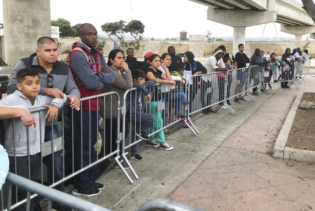 In this Thursday, Sept. 26, 2019 file photo asylum seekers in Tijuana, Mexico, listen to names being called from a waiting list to claim asylum at a border crossing in San Diego. [File photo: AP]