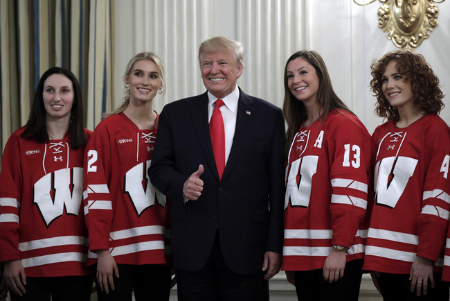 U.S. President Donald Trump poses for a picture with the University of Wisconsin-Madison women's hockey team in the State Dining Room during the NCAA Collegiate National Champions Day at the White House on November 22, 2019 in Washington, DC. [Photo: VCG]