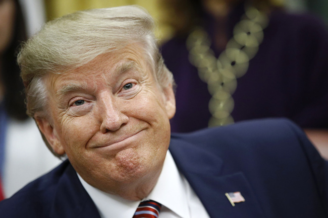 resident Donald Trump participates in a bill signing ceremony for the Women's Suffrage Centennial Commemorative Coin Act in the Oval Office of the White House, Monday, Nov. 25, 2019, in Washington. [Photo: AP/Patrick Semansky]