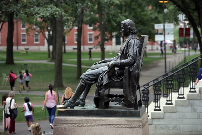 In this Aug. 13, 2019, file photo, the statue of John Harvard looks over Harvard Yard at Harvard University in Cambridge, Mass. [Photo: AP]