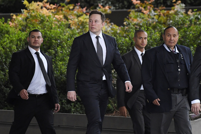 Tesla CEO Elon Musk, second from left, arrives at U.S. District Court Wednesday, Dec. 4, 2019, in Los Angeles. Musk is going on trial for his troublesome tweets in a case pitting the billionaire against a British diver he allegedly dubbed a pedophile. [Photo: AP/Mark J. Terrill]