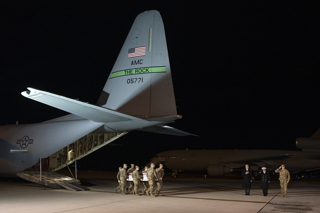 An Air Force carry team moves a transfer case containing the remains of Seaman Apprentice Cameron Scott Walters, Sunday, Dec. 8, 2019, at Dover Air Force Base, Del. [Photo: AP/Cliff Owen]