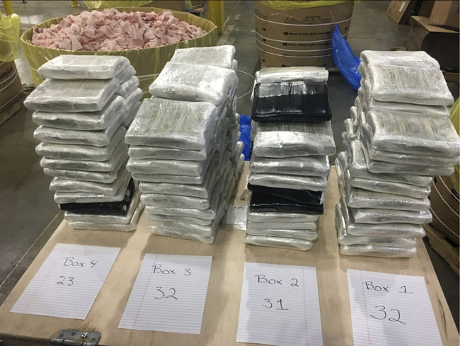 In this December 2019 photo provided by the Cleveland County Sheriff's Office in Shelby, N.C., approximately $3 million in cash, wrapped in plastic, is displayed near the barrels of raw pork shoulder in which it was discovered in. North Carolina deputies recovered the barrels Saturday, Dec. 7, 2019, from a tractor trailer they pulled over. [Photo: Cleveland County Sheriff's Office via AP]