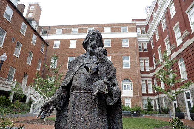 A Jesuit statue is seen in front of Freedom Hall, formerly named Mulledy Hall, on the Georgetown University campus in Washington on Sept. 1, 2016. [Photo: AP/ Jacquelyn Martin] 