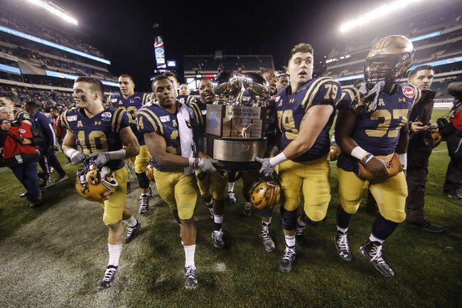 Navy midshipmen carrie off the Commander in Chief's trophy after defeating Army in an NCAA college football game, Saturday, Dec. 14, 2019, in Philadelphia. Navy won 31-7. [Photo: AP/Matt Rourke]