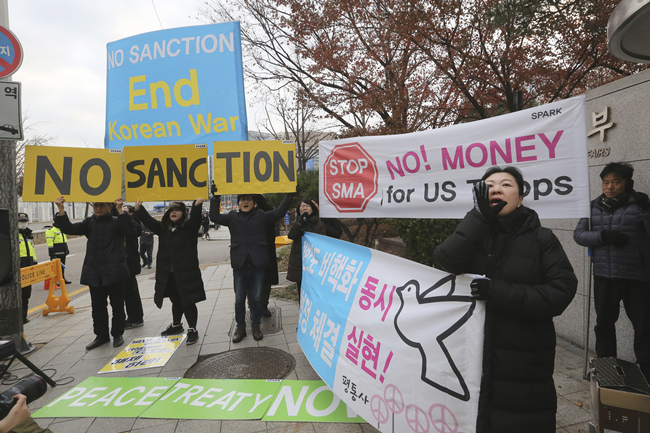 South Korean protesters hold signs during a rally to demand the peace on the Korean peninsula and to stop sanctions against North Korea in front of Foreign Ministry before U.S. Special Representative for North Korea Stephen Biegun's arrival to meet his South Korean counterpart Lee Do-hoon, in Seoul, South Korea, Monday, Dec. 16, 2019. [Photo: AP]