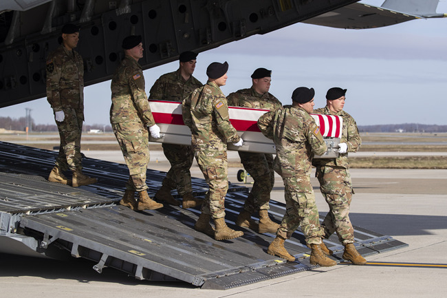 An Army carry team moves a transfer case containing the remains of U.S. Army Sgt. 1st Class Michael Goble, Wednesday, Dec. 25, 2019, at Dover Air Force Base, Del. [Photo: AP]