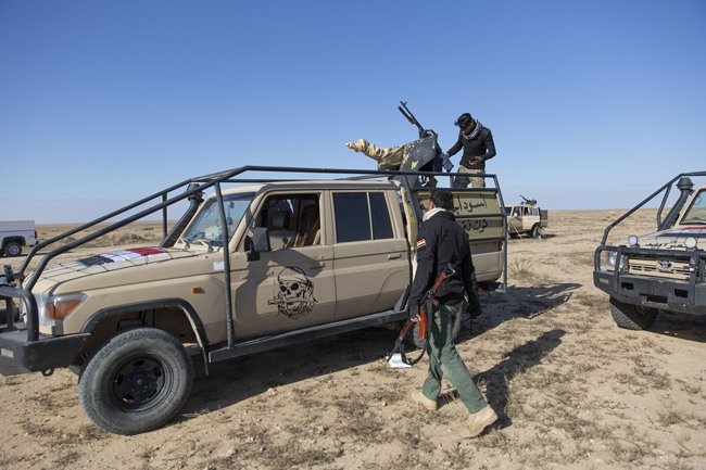 Paramilitary Popular Mobilization Forces and local tribal militias participate in the military operations of the Iraqi army Seventh Brigade, at the start of the eighth phase of the operation, in Anbar, Iraq, Sunday, Dec. 29, 2019. [Photo: AP /Nasser Nasser]