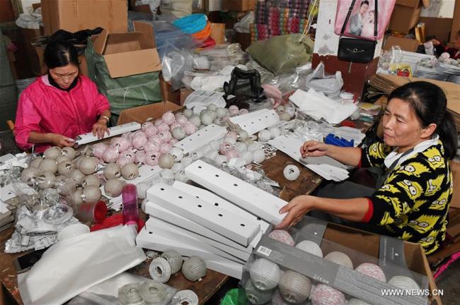 Des ouvrières emballent des lanternes en papier dans une usine à la ville de Jian'ou de la province chinoise du Fujian (sud-est), le 4 novembre 2018. Des lanternes en papier produites par des entreprises et des ateliers locaux sont exportées vers les marchés d'Europe, d'Amérique du Nord et d'Asie du Sud-Est.(Xinhua/Zhang Guojun)