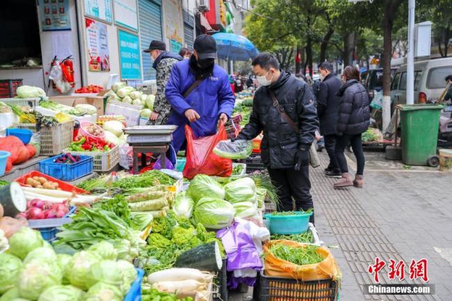 Des habitants achètent des légumes sur un marché agricole en plein air dans le district de Jianghan à Wuhan, chef-lieu de la province du Hubei (centre), le 10 février 2020. Les autorités de la ville ont poussé la reprise du fonctionnement des marchés agricoles pour assurer l’approvisionnement des fournitures quotidiennes des habitants de la ville. Au 8 février, un total de 14 marchés dans la rue avaient été mis en service. (Photos: Zhang Chang/Chinanews)