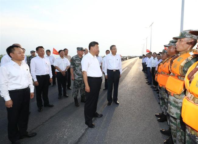 Ο Κινέζος Πρόεδρος Σι Τζινπίνγκ, επίσης γενικός γραμματέας της Κεντρικής Επιτροπής του Κομμουνιστικού Κόμματος της Κίνας και πρόεδρος της Κεντρικής Στρατιωτικής Επιτροπής, εκφράζει τις ευχαριστίες του σε όσους αγωνίζονται για τις πλημμύρες στην πρώτη γραμμή, συμπεριλαμβανομένων στρατιωτικών από το Λαϊκό Απελευθερωτικό Στρατό και Λαϊκή Ένοπλη Αστυνομική Δύναμη, σε ένα τμήμα ενός φράγματος στην κομητεία Φεϊντόνγκ της Χεφέι, πρωτεύουσα της επαρχίας Ανχούι της ανατολικής Κίνας, στις 19 Αυγούστου 2020. (φωτογραφία / Xinhua)