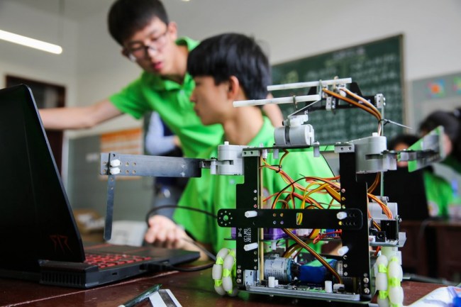 Nxënësit përshtatin robotë gjatë një konkursi në kontenë Longhui të qytetit Shaoyang në provincën Hunan të Kinës Qendrore.