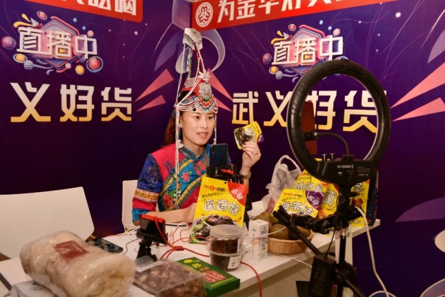 Στην φωτογραφία, η Λαν Λιτσούν μια ραδιοτηλεοπτική παρουσιάστρια της εθνότητας Σε, προωθεί τοπικές σπεσιαλιτέ της κομητείας Γουγί, στην πόλη Τζινχουά κατά τη διάρκεια της ζωντανής εκδήλωσης γυναικών στην πόλη Γιγού, στην επαρχία Τζετζιάνγκ της Ανατολικής Κίνας, στις 18 Αυγούστου 2020. [Γυναικεία Ομοσπονδία Yiwu]